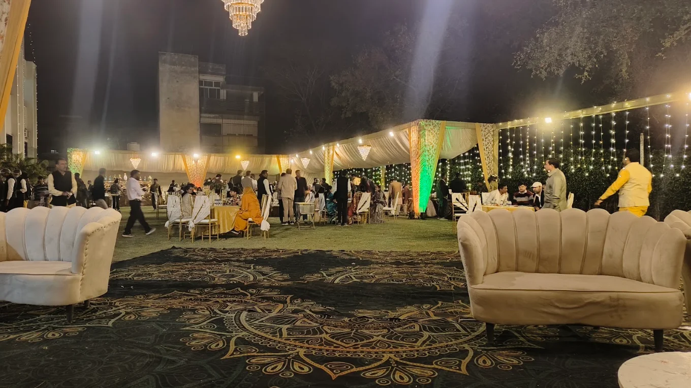 Outdoor evening wedding reception with chandelier and fairy lights