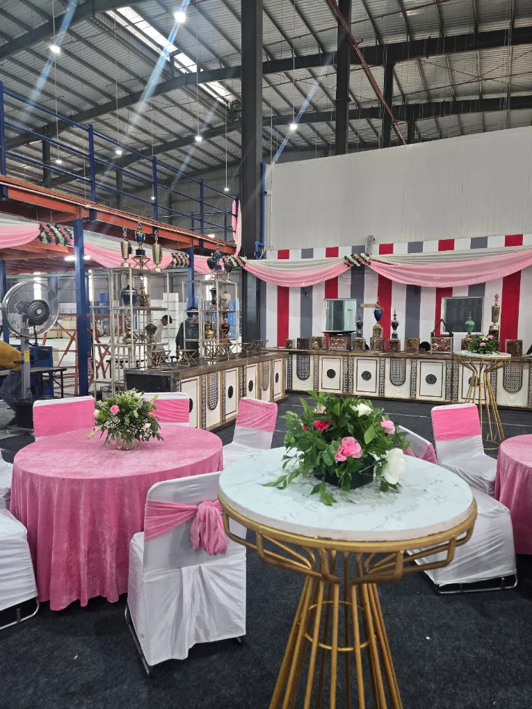 Pink themed round table setup with floral centerpieces