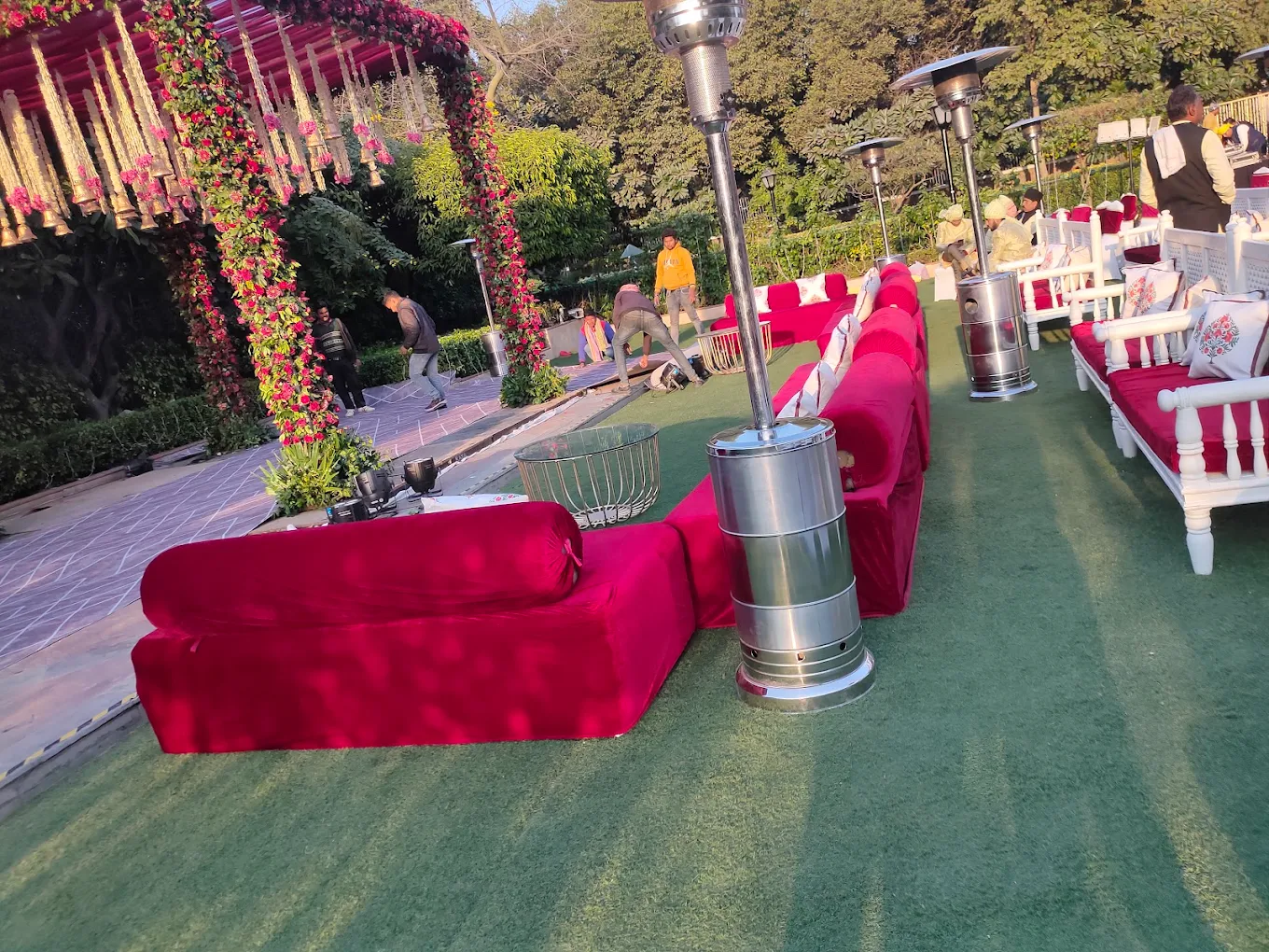 Red velvet outdoor lounge seating with floral mandap