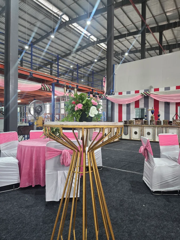 Pink themed birthday hall decoration with cocktail table